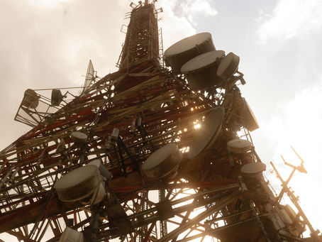 Why should companies in the telecom industry outsource to India?