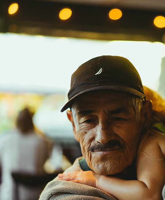 A grandfather hugging his grandchild