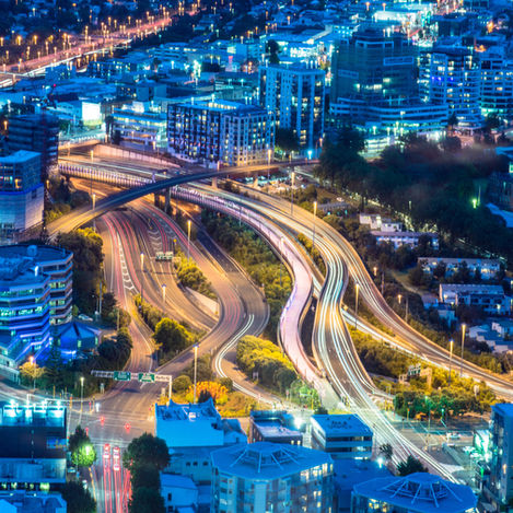 View of Auckland city at night, representing the scale and diversity of the rental market managed by property managers.