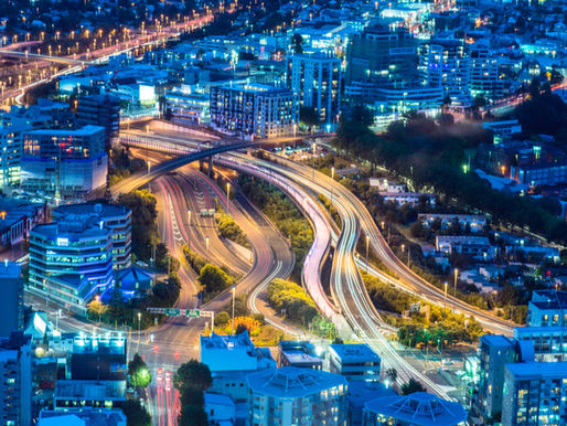 View of Auckland city at night, representing the scale and diversity of the rental market managed by property managers.