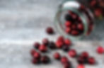 Cranberries spilling from a glass jar