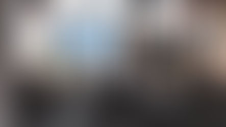 Senior communications leaders in a boardroom reviewing insights on a screen, illustrating how AI supports strategic discussion and human judgement in PR and communications rather than replacing decision-making.