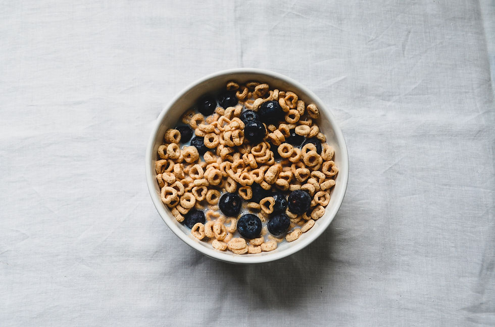heart shaped bowl of cheerios with blueberries