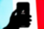A person holding an IPhone with the TikTok App logo on it