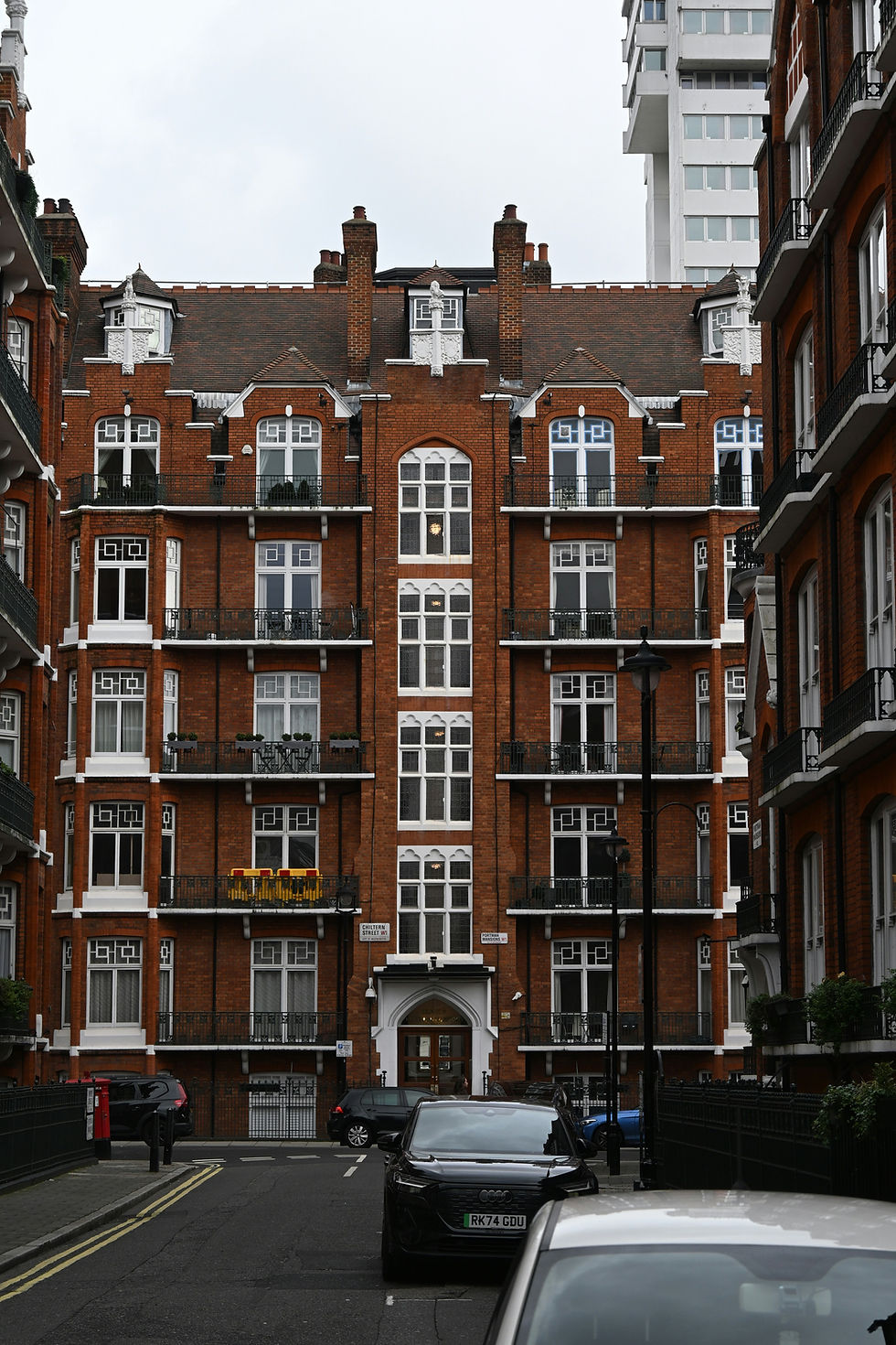 Red brick apartment building with white window frames