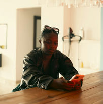 woman on phone at dining table
