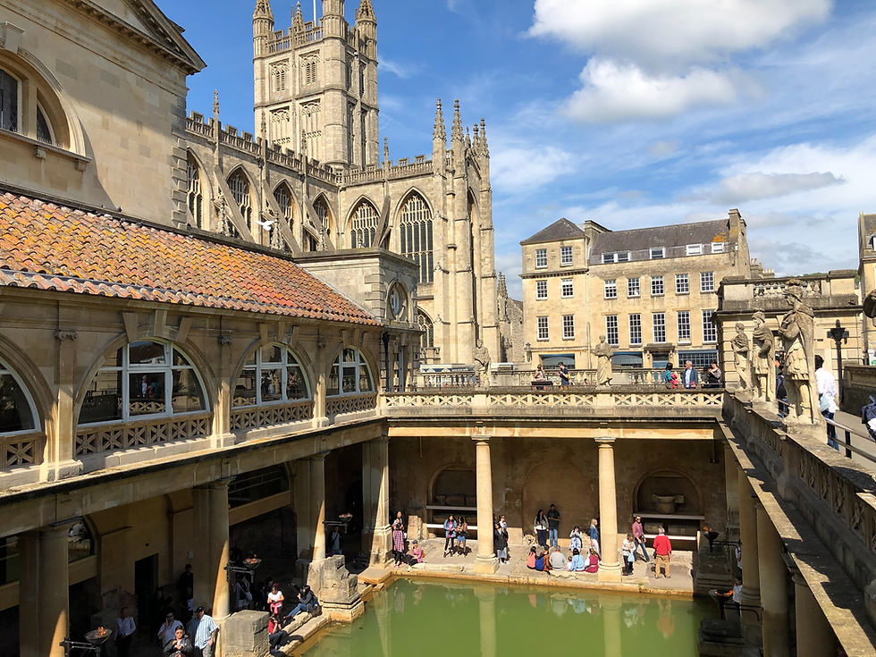 Roman columns frame the Great Bath as Bath Abbey rises behind, two thousand years of layered beauty visible in a single glance. Photo by Zac Farmer on Unsplash