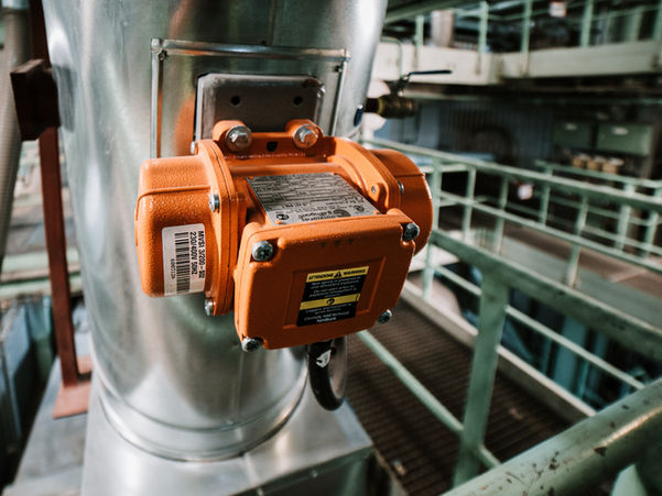 Electrical motor installed on side of pipe.