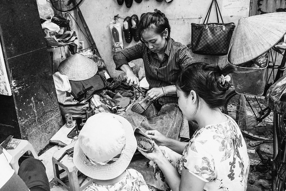 Women shown making shoes in small workshop
