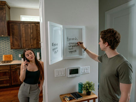 Smart home installer configuring control panel in modern kitchen