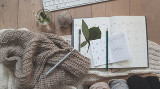 Writing space with crochet tools and notebook