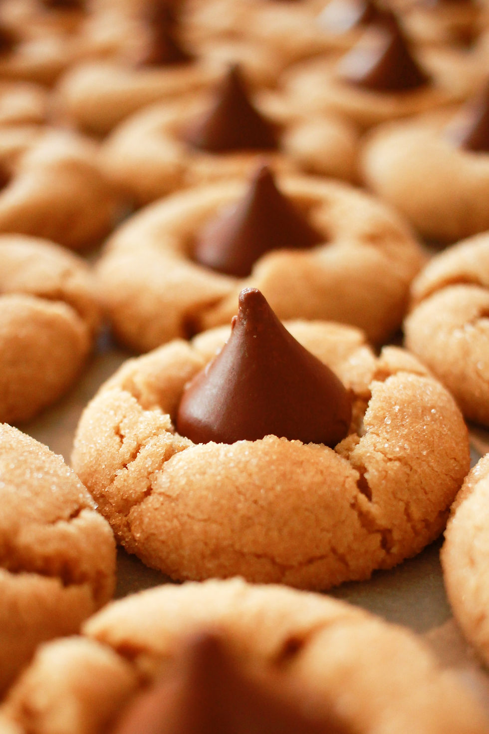 A tray of cookies with chocolate kisses pressed into them