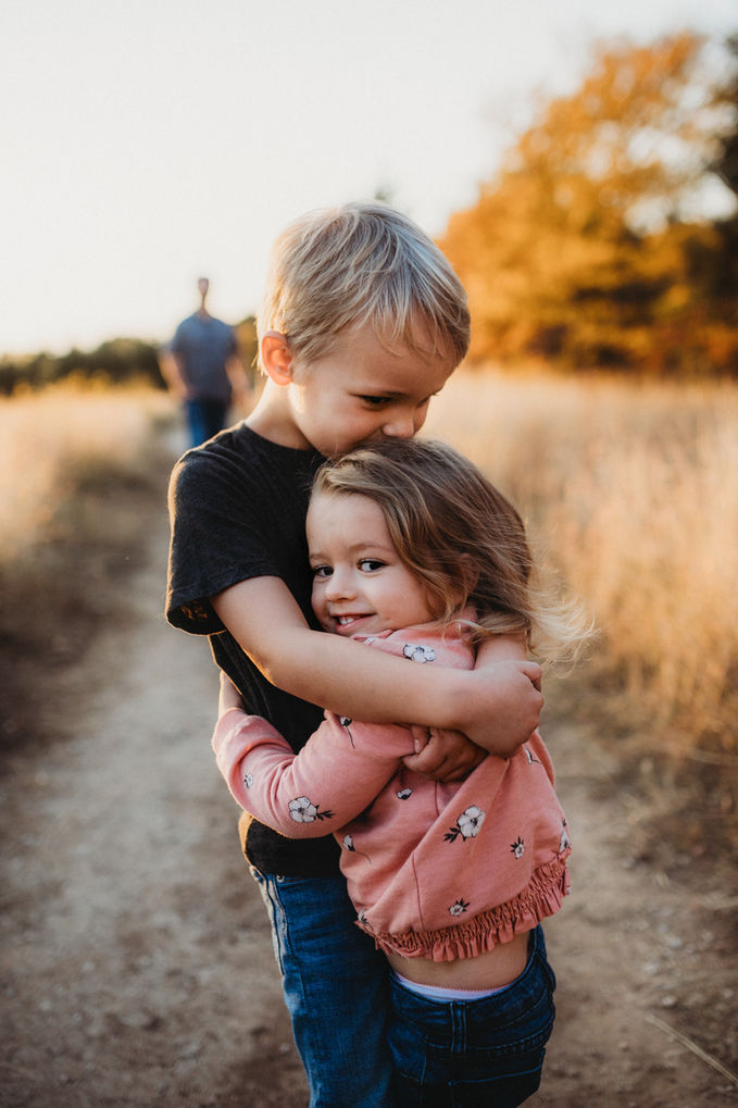 Children Photography by Blake Ferguson depicts a Brother and Sister hugging in the Farmland of Ontario, Canada.