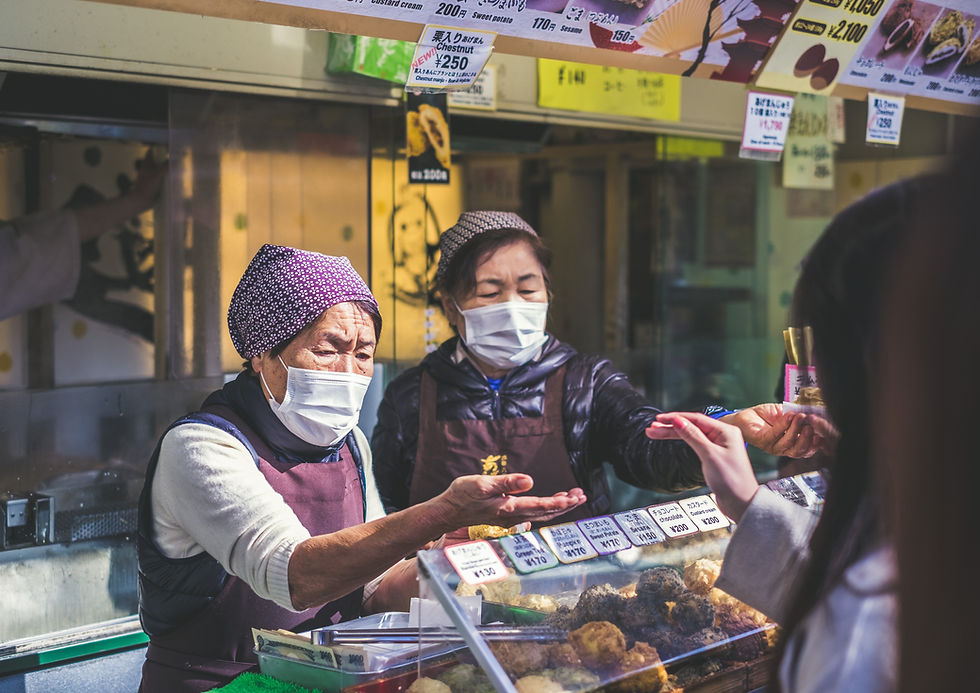 Women in China wear face masks while working at a cafe