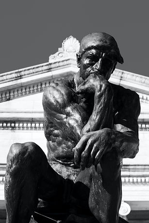 Statue of a man thinking, to represent the practice of socratic questioning.