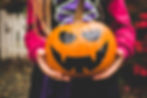 Child holding Jack-o-lantern on Halloween 