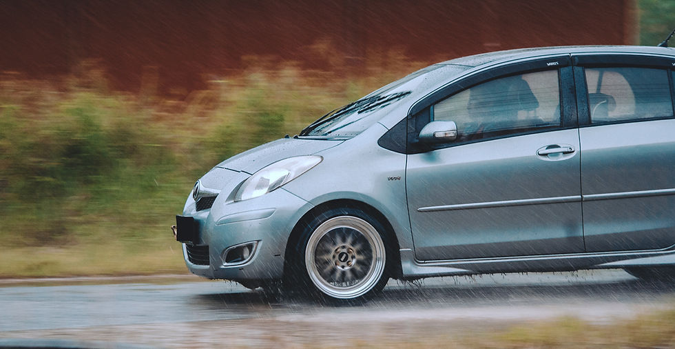 Car cruising in the rain