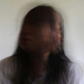A distorted image of a blurred woman experiencing dissociation.