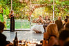 Maid of honor is presenting her wedding speech in front of the wedding couple