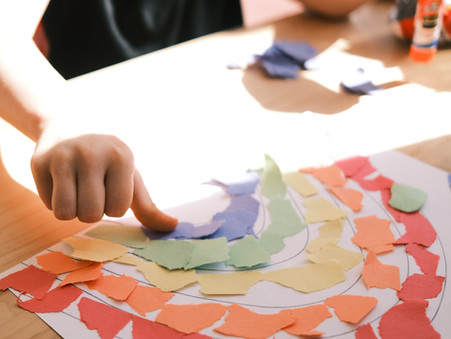 child doing a rainbow paper craft