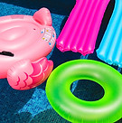 Pink flamingo pool float with other inflatables