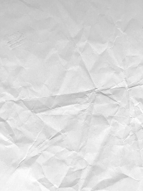 Crumpled white paper texture with creases and folds.