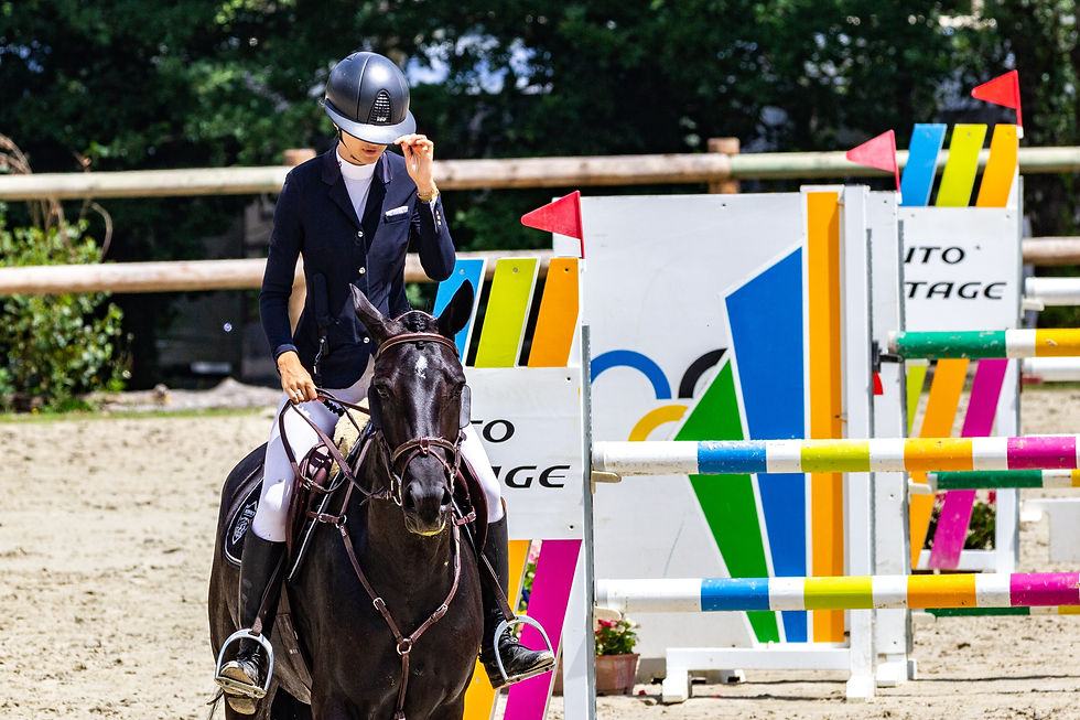 girl finishing her hunter jumper round will enhance her horses recovery with red light therapy