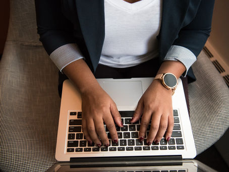 a woman types an auto-reply on her computer