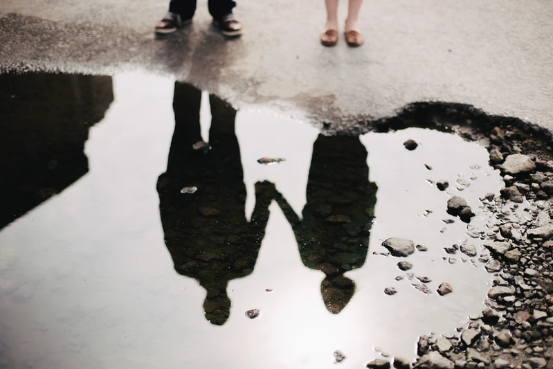 couple holding hands in  reflection