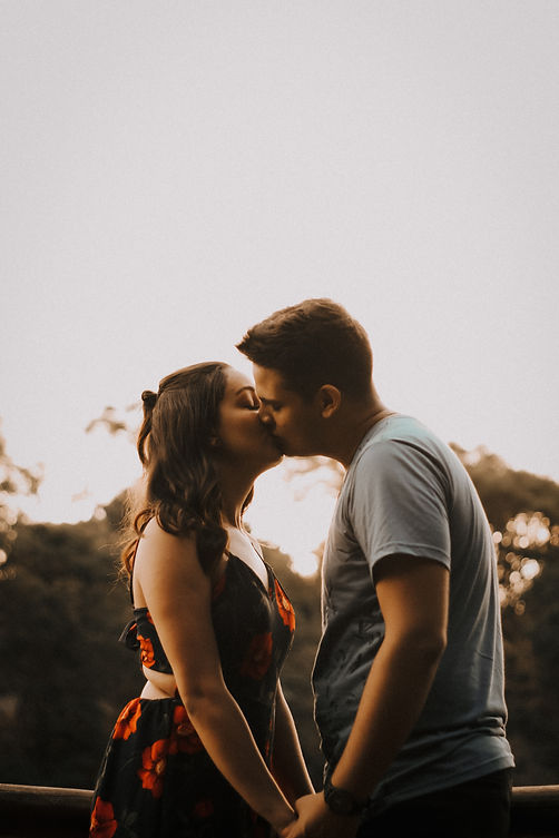 Couple sharing a kiss under the sunset