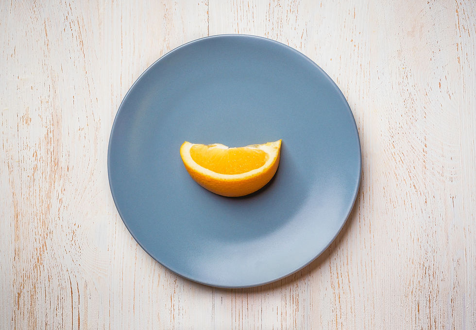 A single orange slice on a blue plate: AIP elimination diets can be very restrictive