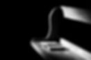 Black and white photo of empty pew with bible on it.