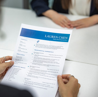 stock photo of a person's hands holding a resume
