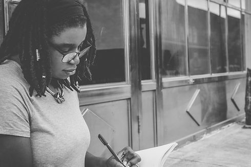 Young woman writing in a notebook.
