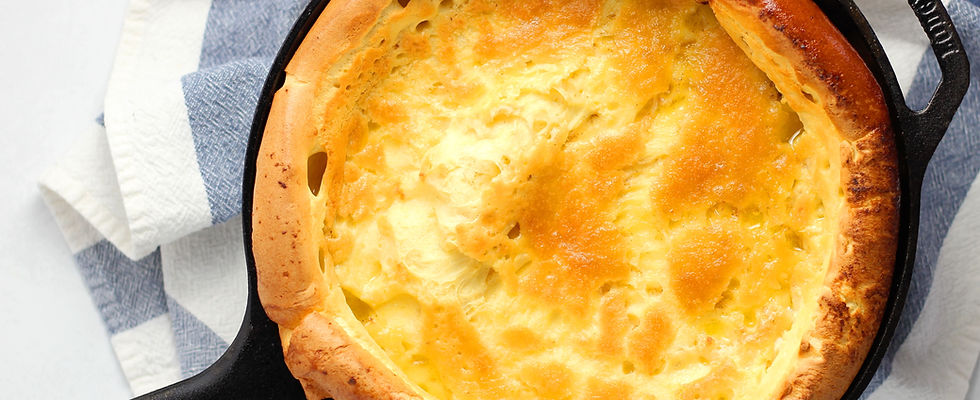 Cast-iron skillet cornbread with a golden crust, served with honey butter