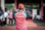 Volunteer stands facing campaign area to take a photograph