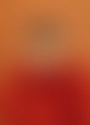 Woman holding oranges to her eyes smiling