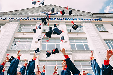 graduates throwing up their graduation hats