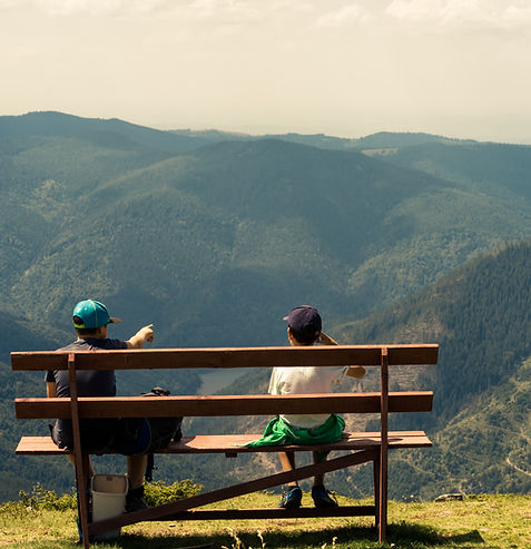 Kinder auf einer Bank im Gebirge