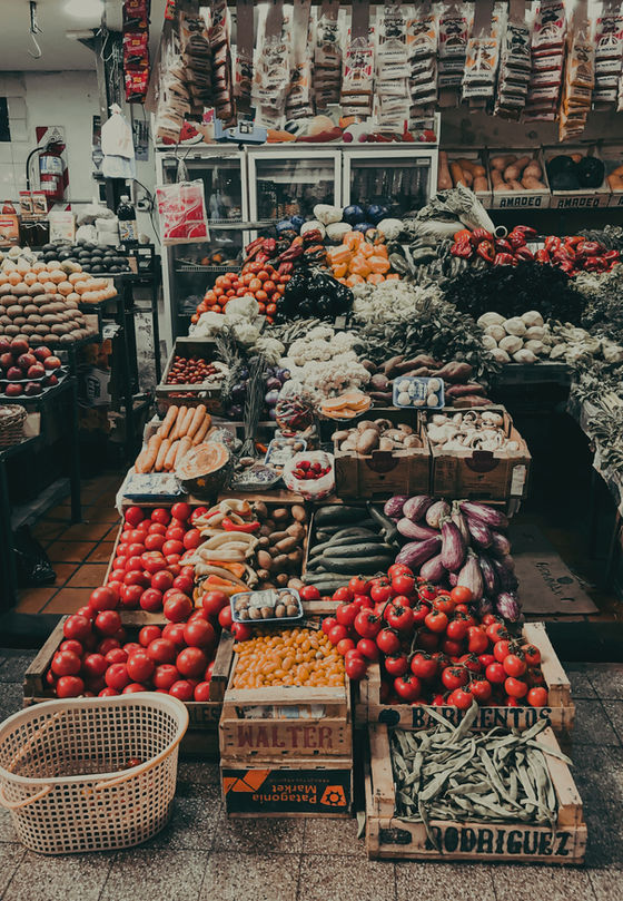 A vibrant market stall brimming with a colorful assortment of fresh fruits and vegetables, showcasing nature's bounty in all its glory.