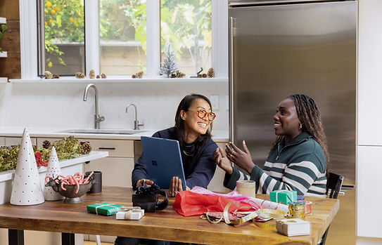 Life coach having a casual conversation in the kitchen with their client
