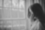 Woman looking through a window
