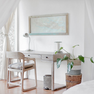 A creative corner with a wooden desk and chair by the window