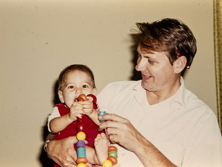 Nostalgic photograph of father holding a baby