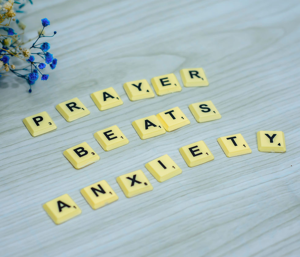 The words 'Prayer beats anxiety' on a surface