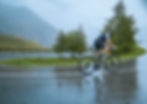 triathlete or cyclist riding in the rain on a road bike on wet road