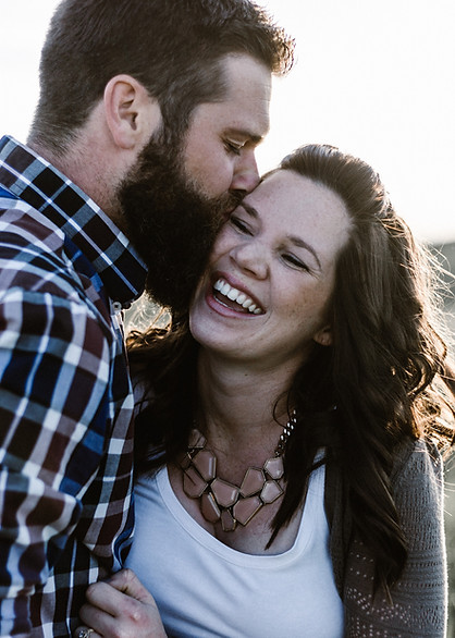 Couple smiling and kissing after relationship counseling in Denver CO