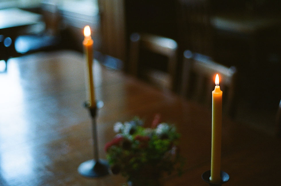 two beeswax candles on a table