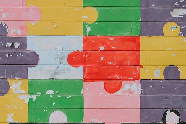 painted colourful jigsaw puzzle pieces fitted together