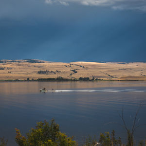 wakeboarding on a blue lake before the approaching storm